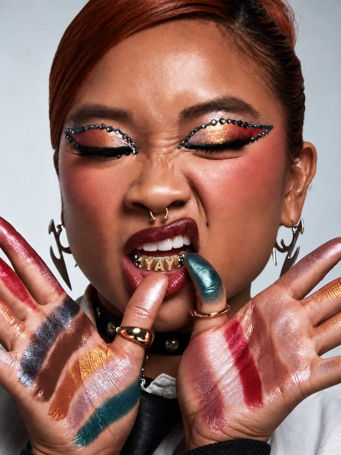 Woman wearing a jeweled eye look and a YAY grill
